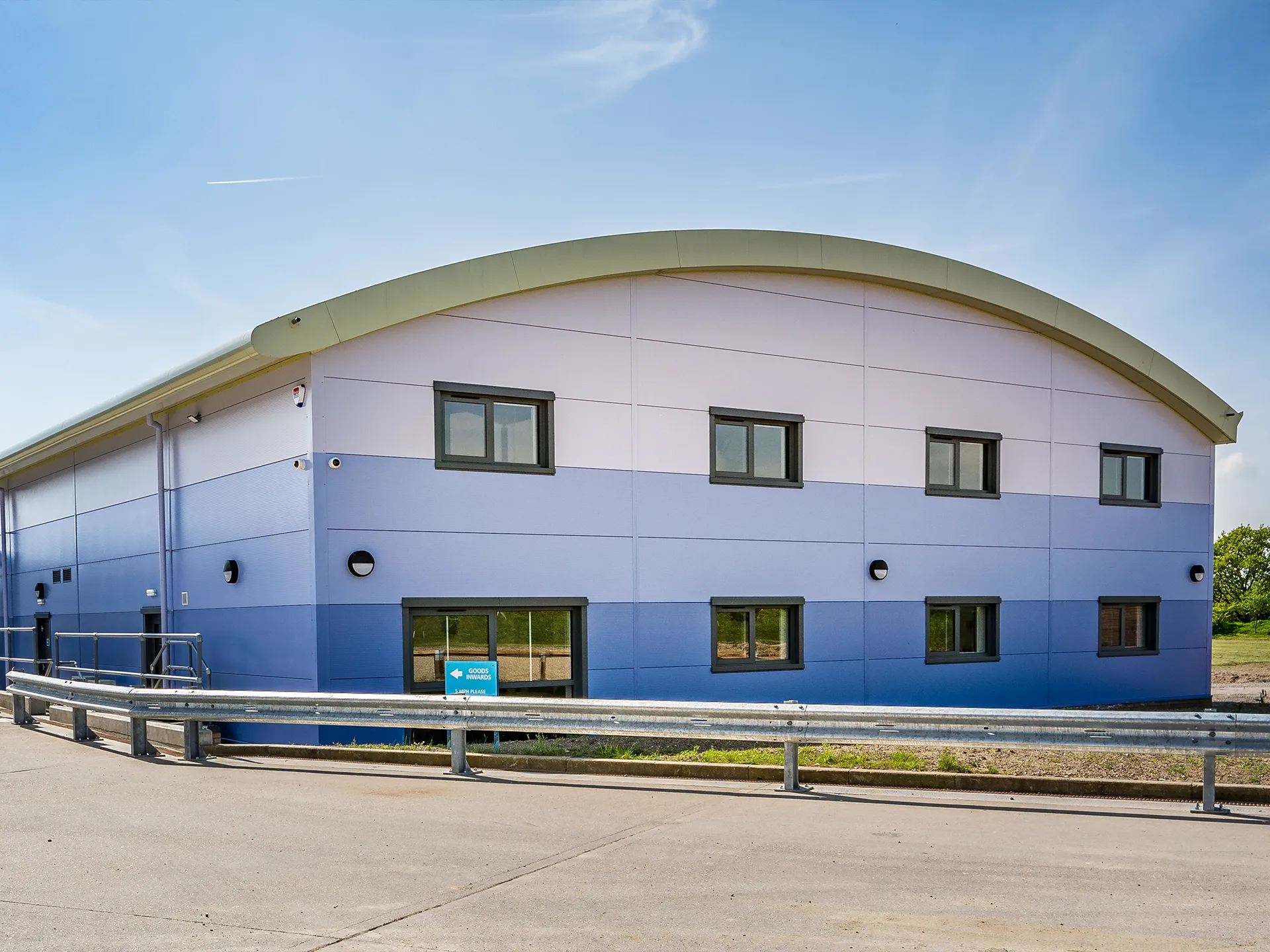 Blue & white warehouse, with curved roof line