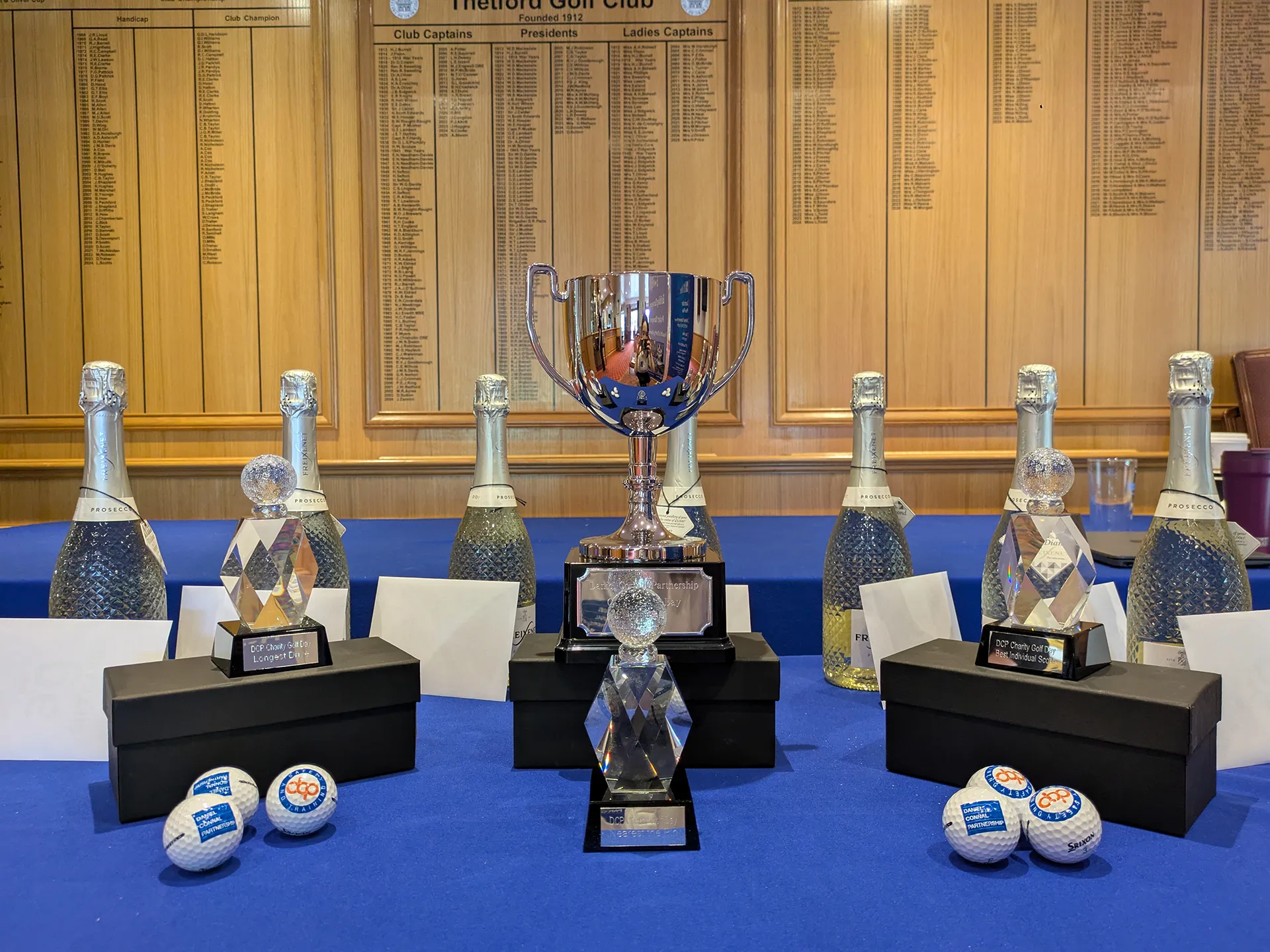 Team of men with golf trophies