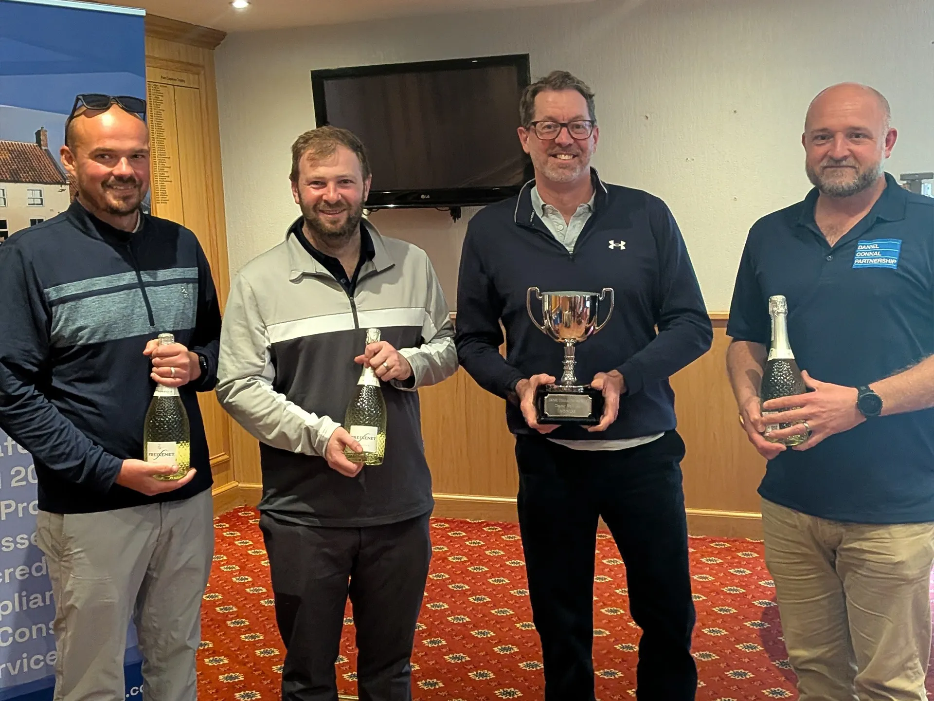Team of men with golf trophies