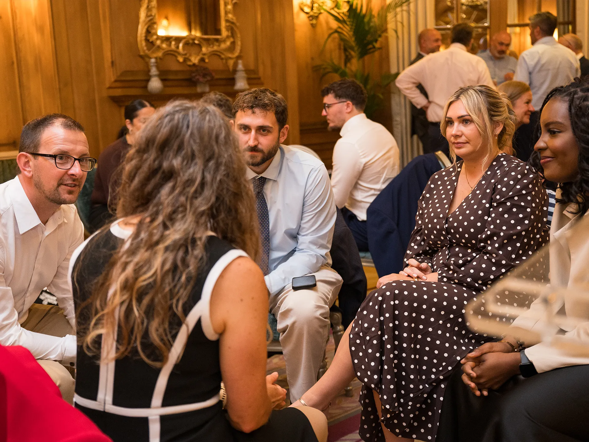 Group of standing people informally chatting over coffee