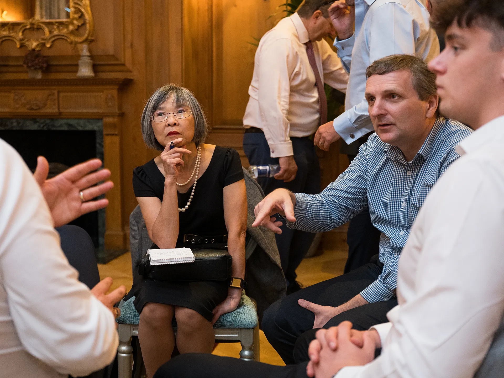 Group of standing people informally chatting over coffee
